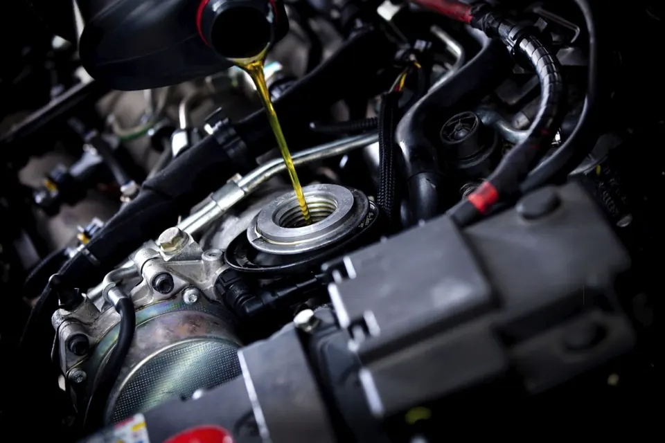 Engine oil being poured into a car engine